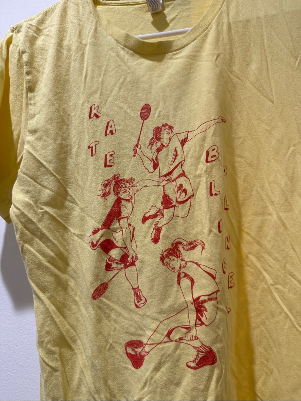 Unisex Kate Bollinger Band Yellow Graphic Badminton Tee with Red Print, size M